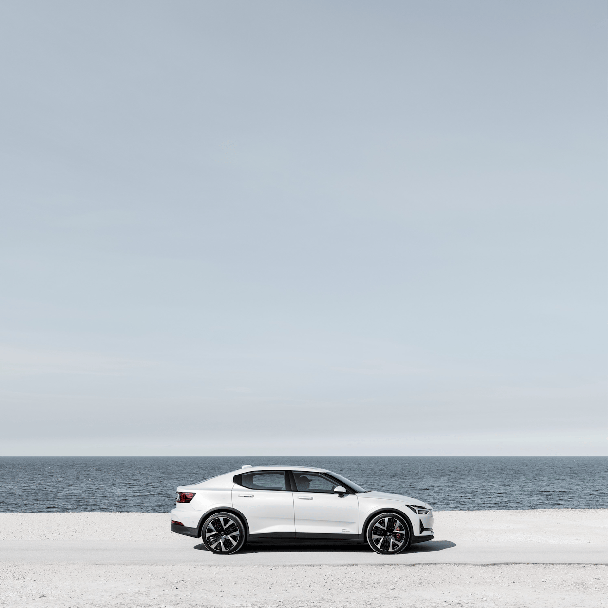 White Polestar seen from the side standing in front of the ocean
