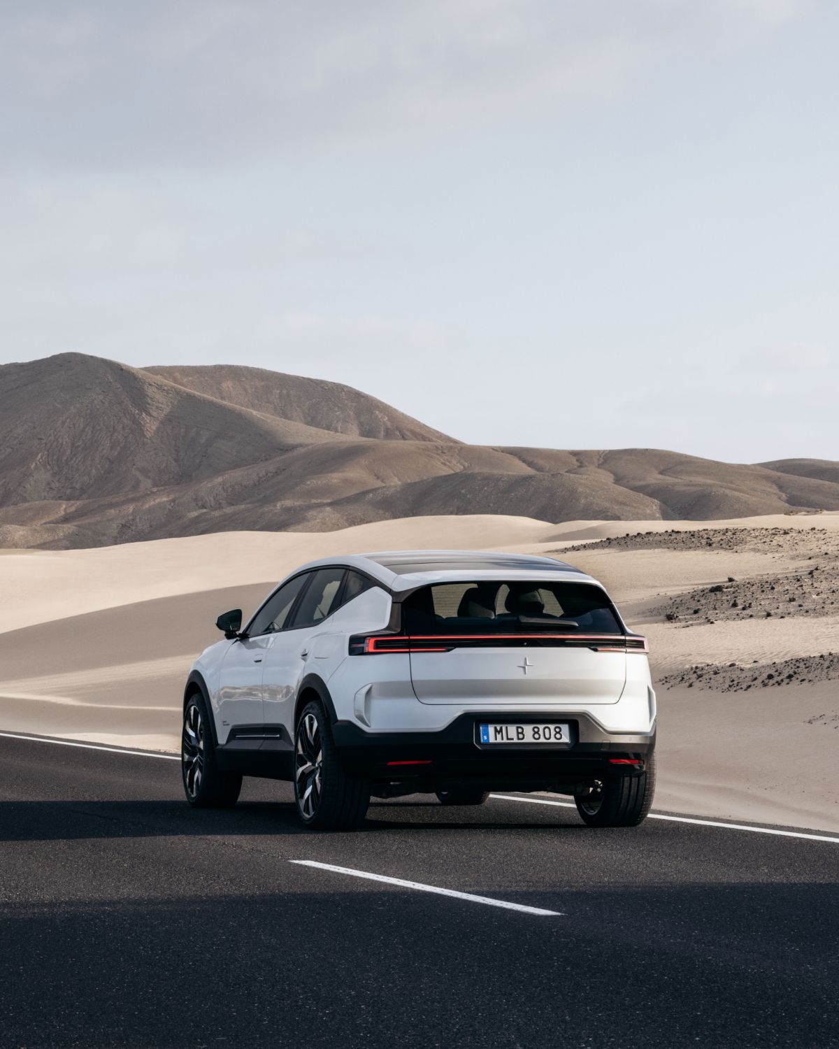 Back of Polestar 3, standing on a road in a desert looking environment