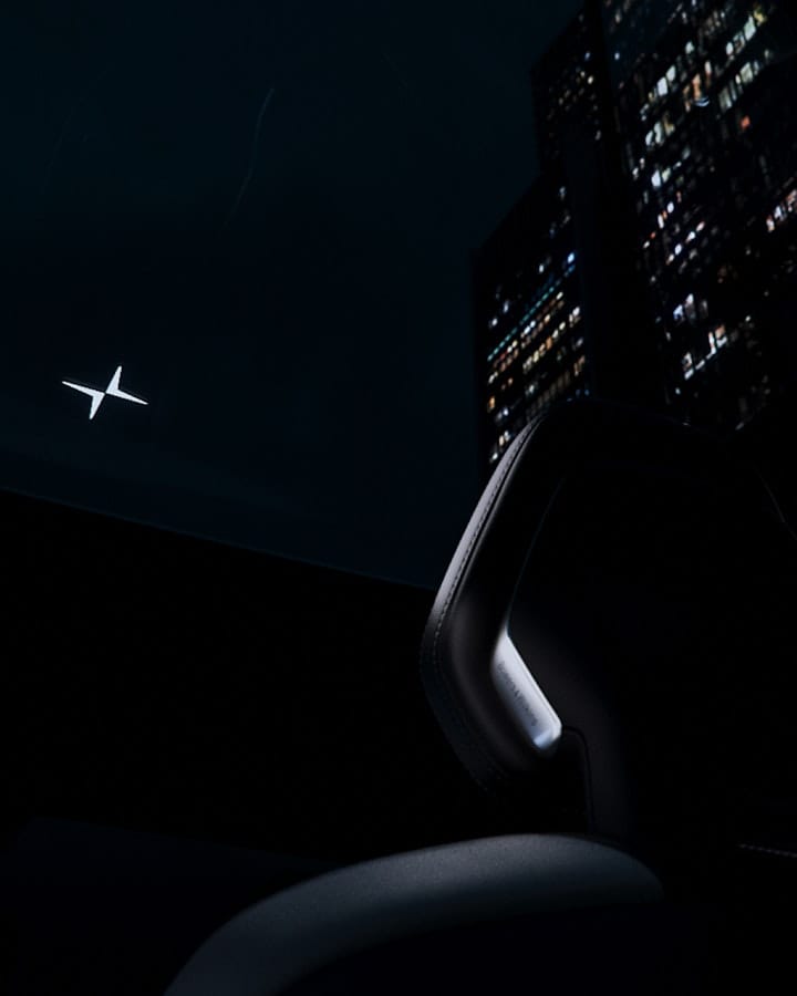 The illuminated Polestar symbol seen from the inside of the car.
