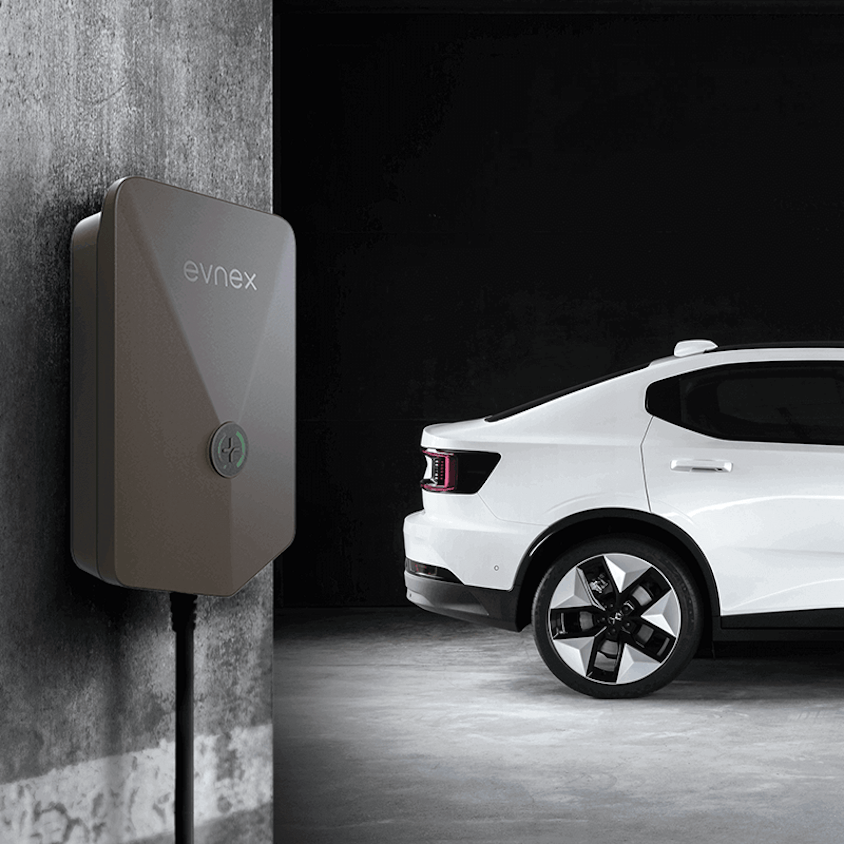 Polestar 2 side view next to wall charger