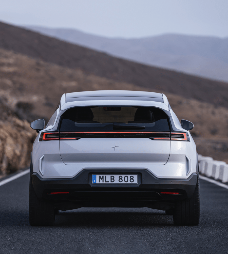 Polestar 3 driving on a road seen from the back.