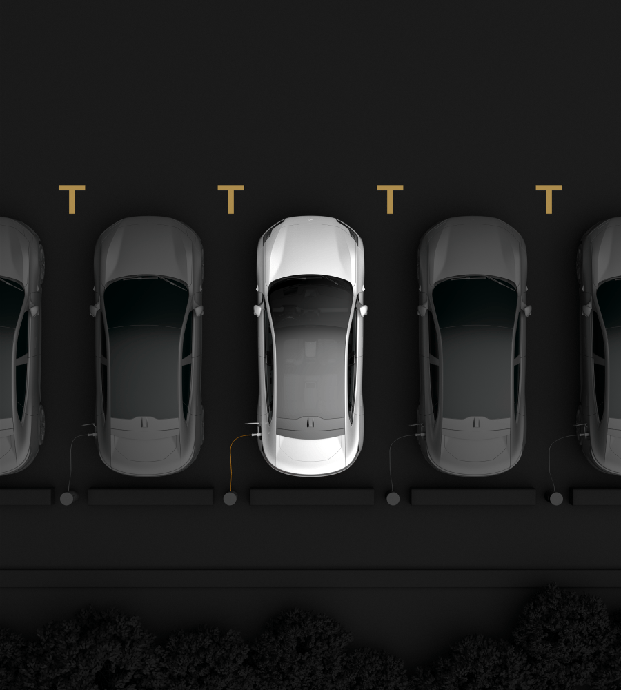 Cars parked in line seen from above.  One white car in the middle and black cars on both sides of it.
