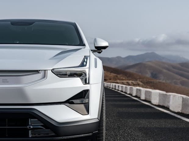 Close-up of the front of a white Polestar 3 with mountains in the background.