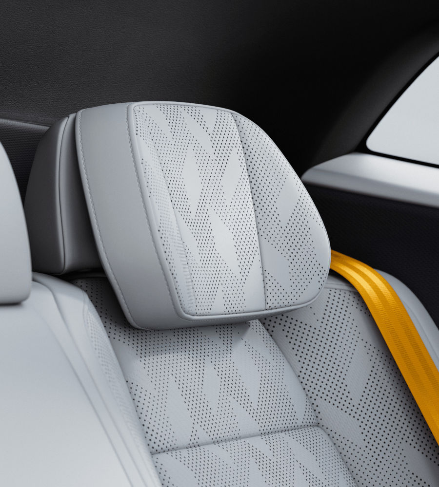 Close-up on headrests in light upholstery, yellow belt.