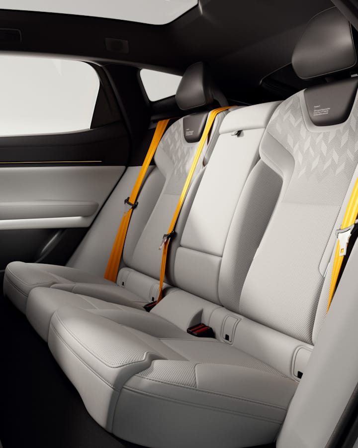 The front and back seats are seen from the side, far apart enough to provide ample leg room.