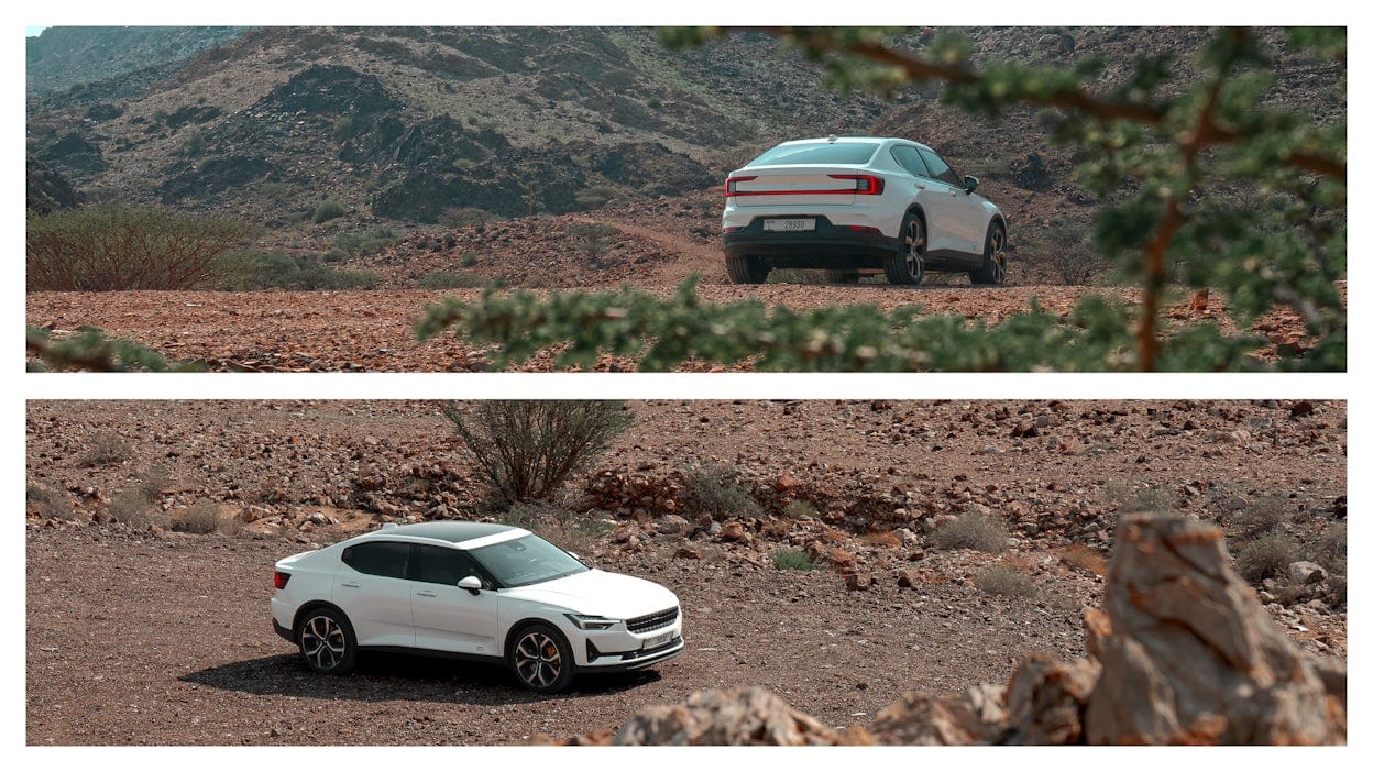 Polestar 2 in the Hajar mountains sourrounded by rock and sand.
