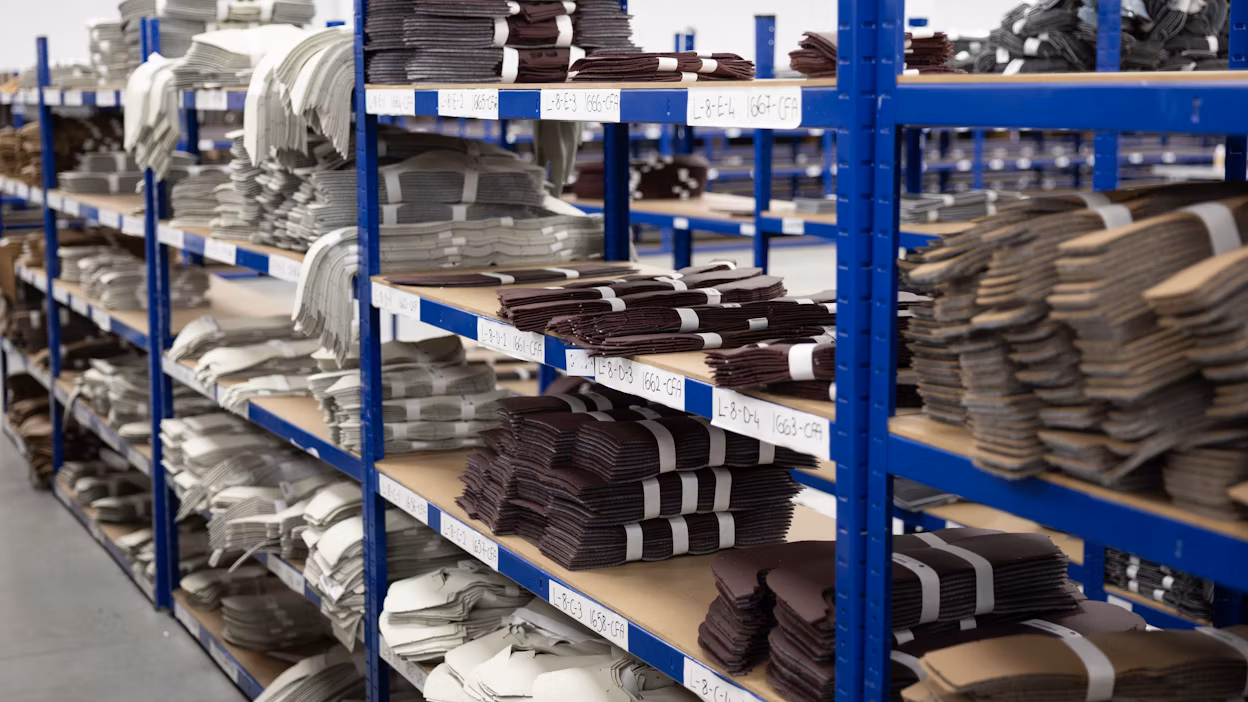 Stacks of cut leather parts.