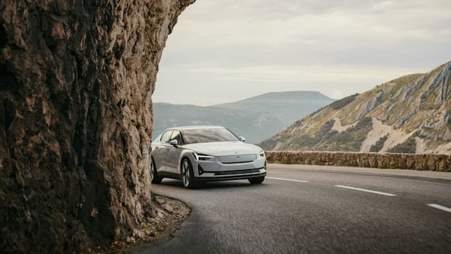A white Polestar 2 driving on a mountain road