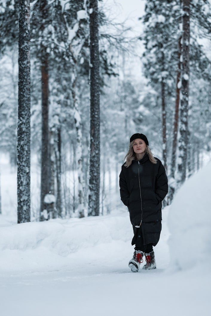 Tanja Sotka walking in the Finnish, snowy, forest
