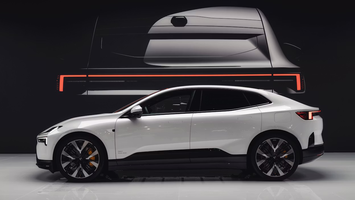 Polestar car in white displayed in profile view with a rear design projection in the background.