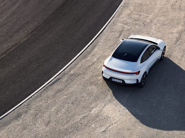 Polestar 4 in white standing still next to a racetrack