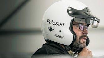 Man putting on Polestar racing helmet