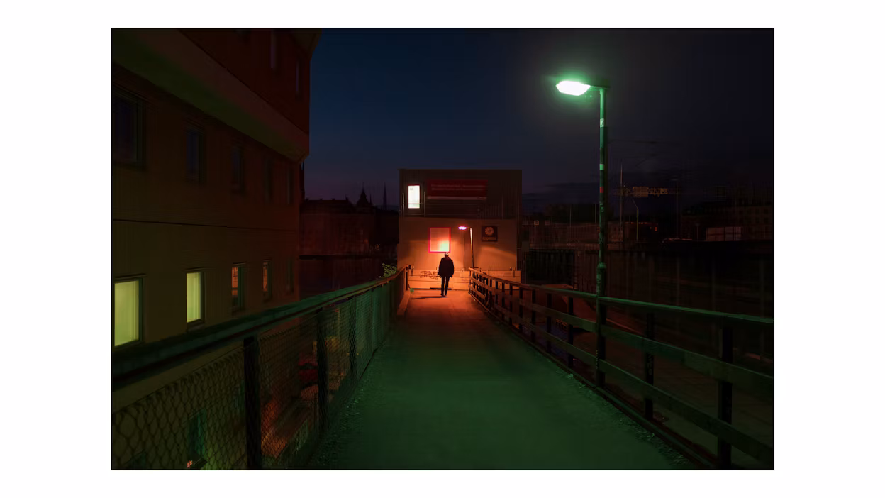 A person walking on a dark bridge.