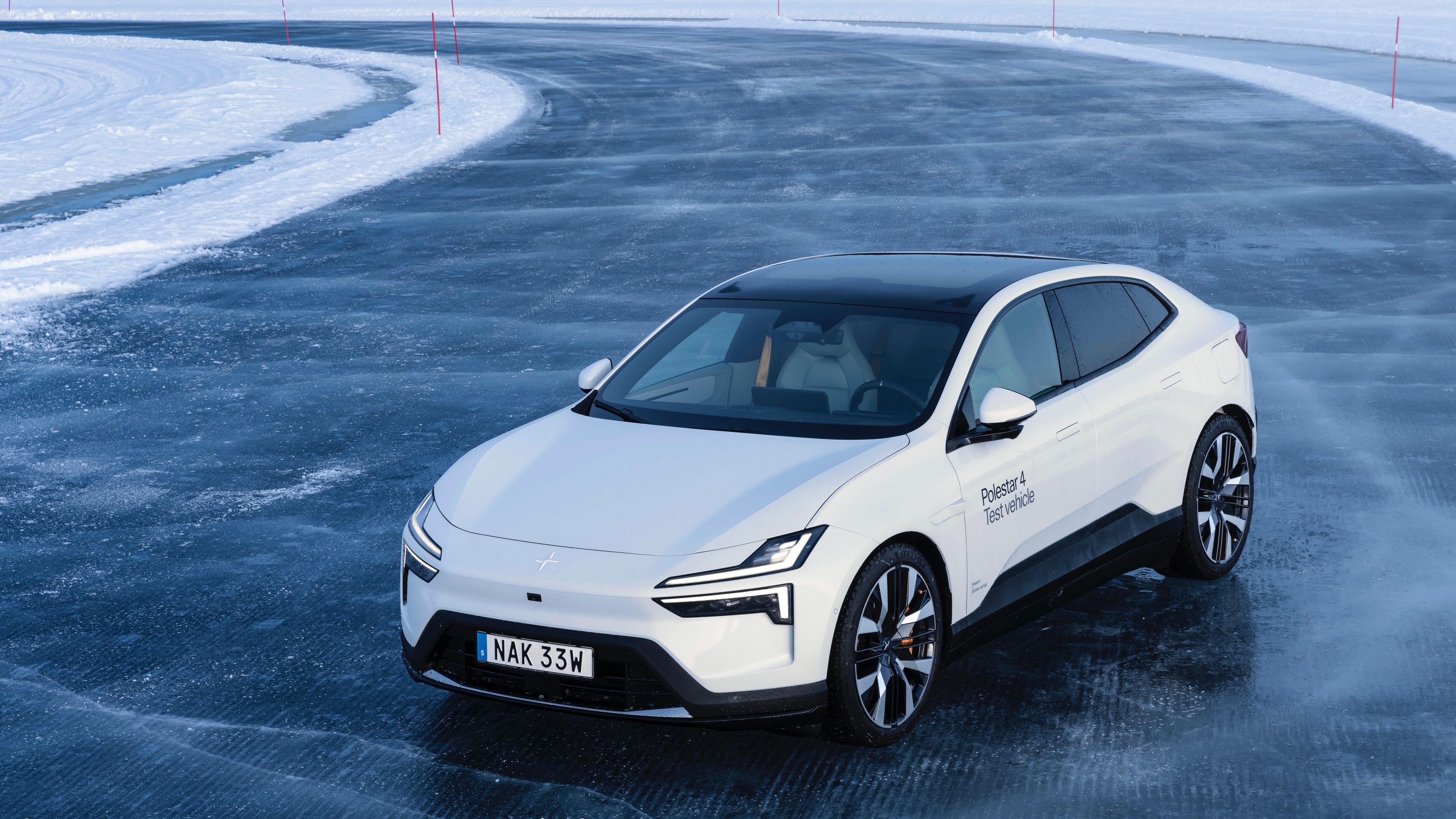 Polestar car on icy road with snow-covered surroundings.