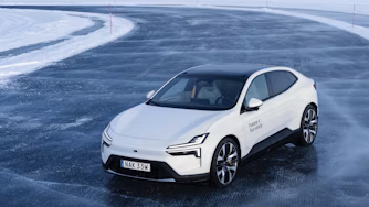 Polestar car on icy road with snow-covered surroundings.