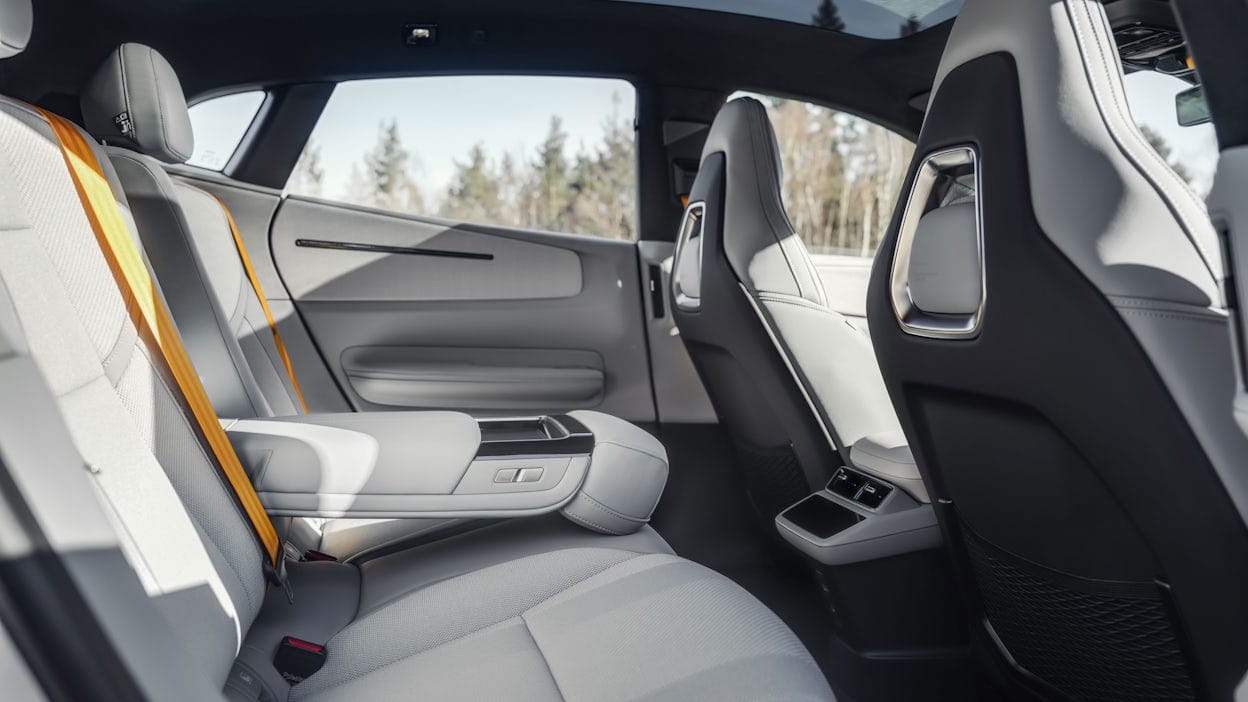 Inside a Polestar 4, showing the rear seats and a yellow seatbelt