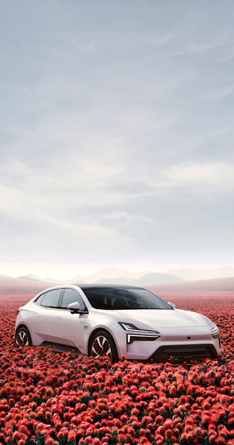 A white Polestar 4 surrounded by red flowers