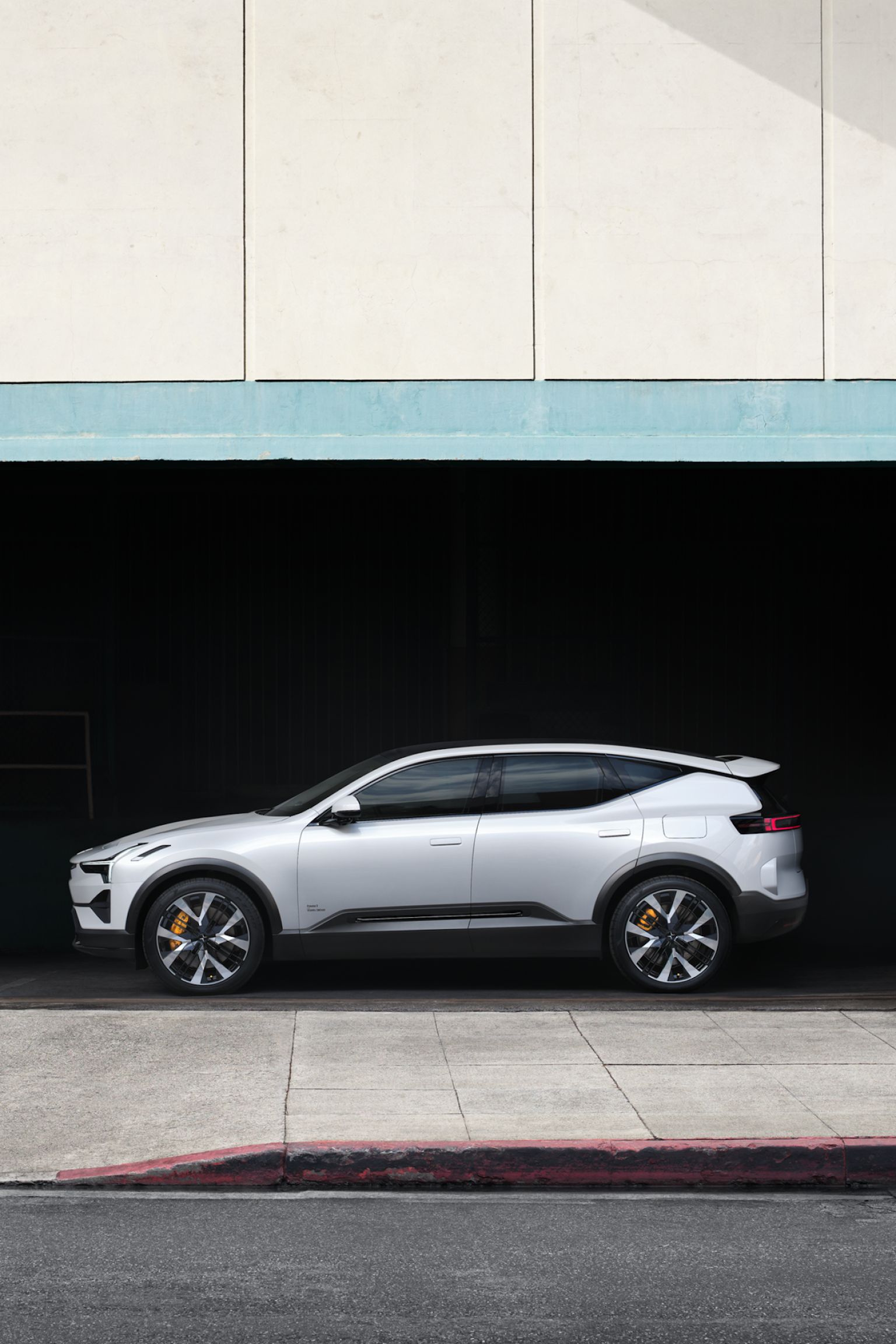 Polestar seen from the side, parked in a building.