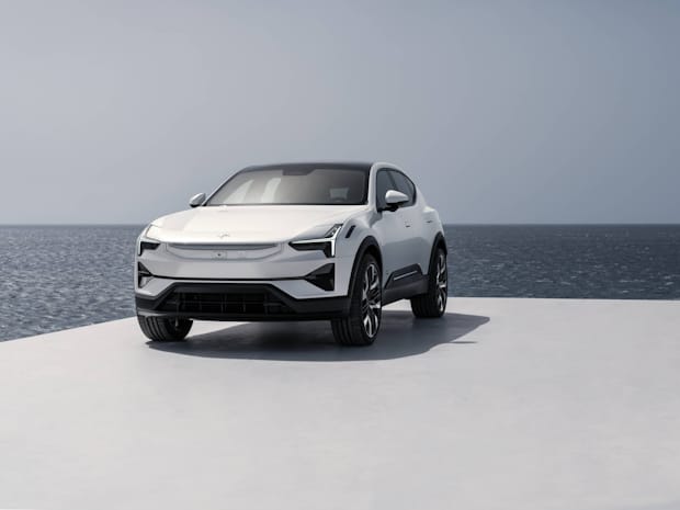 A white Polestar 3 on a platform with the ocean in the background.
