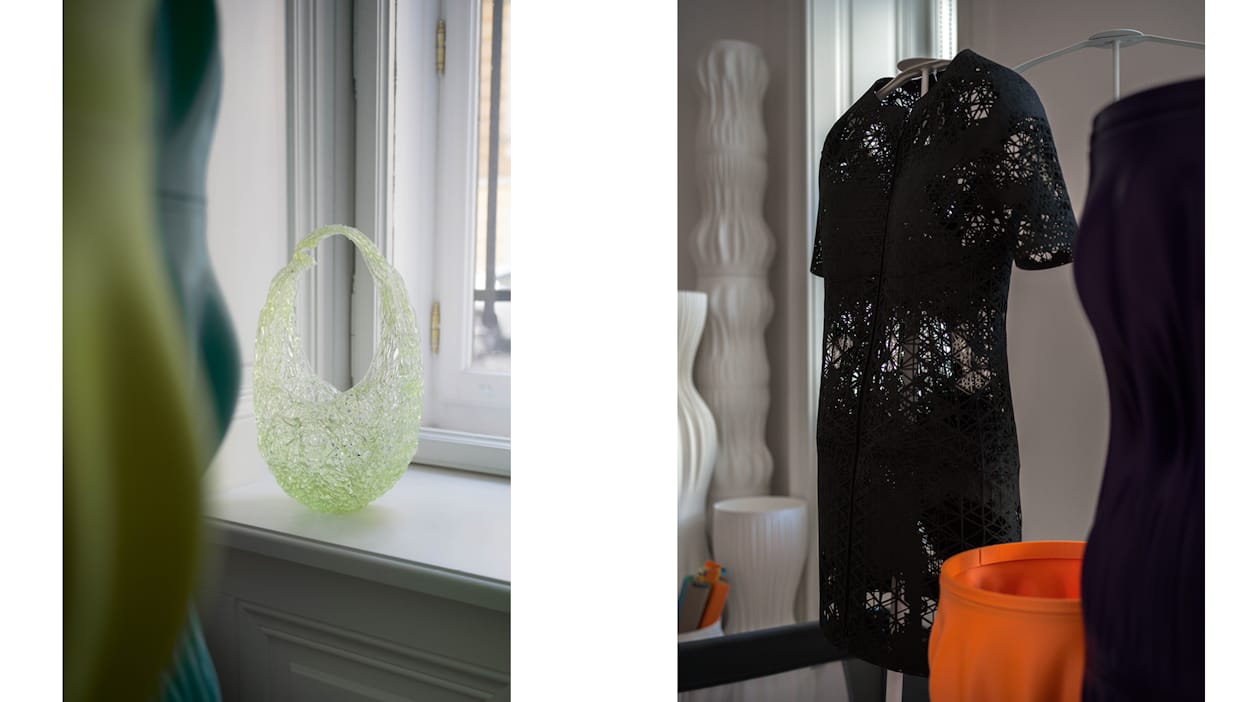 a green 3D printed handbag and a black 3D printed dress