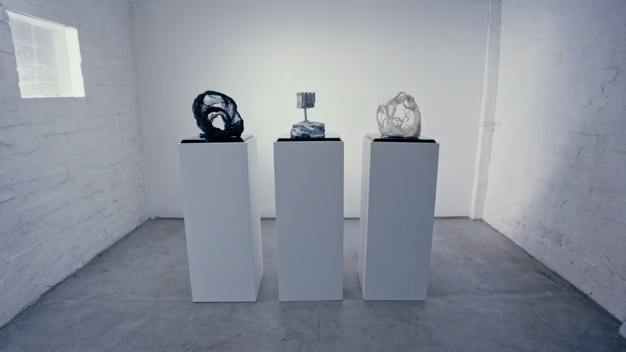 Three sculptures made from recycled materials (aluminium, fishing net and flax), positioned side by side