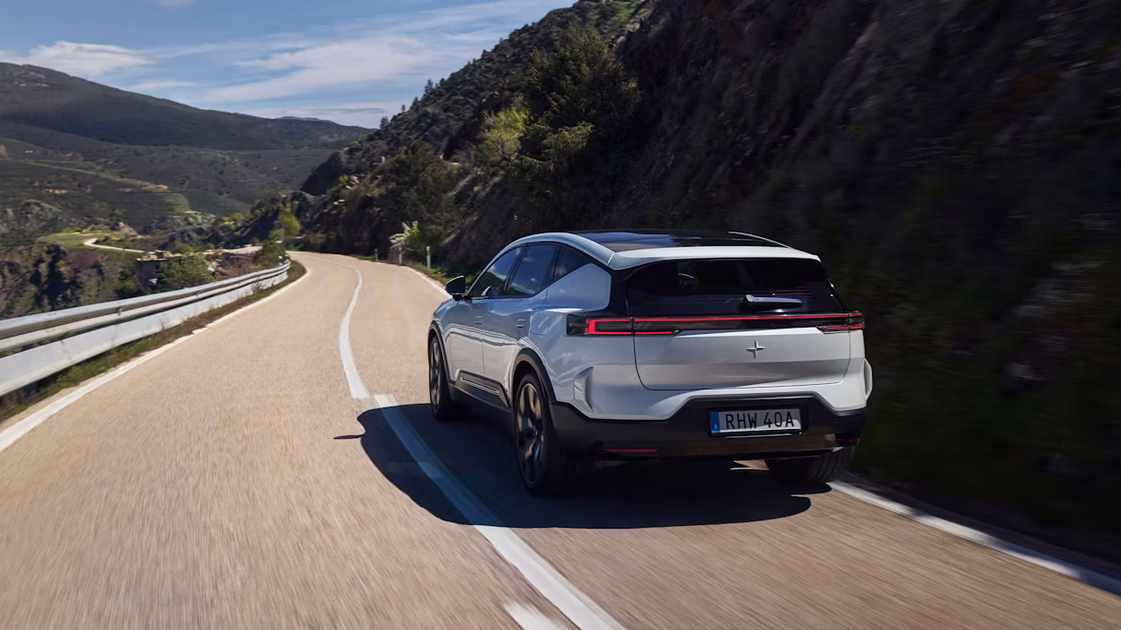 Polestar 3 in Snow color driving on a winding road in Spain