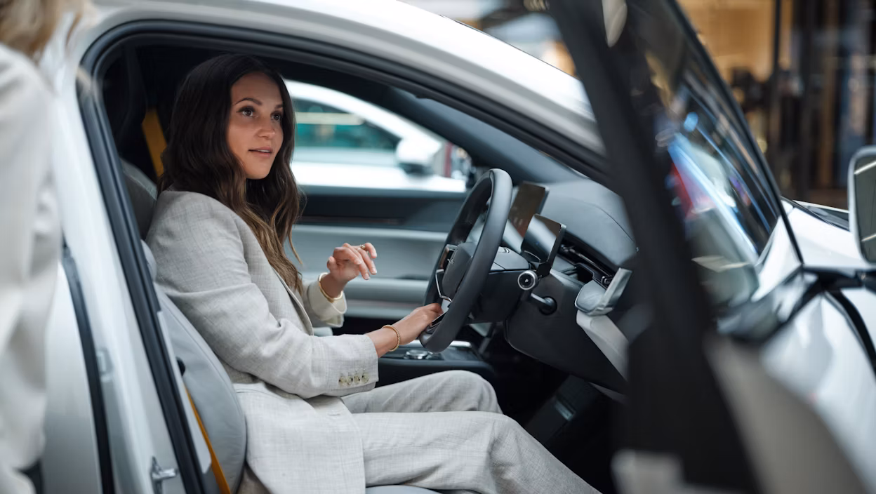 Alicia Vikander sitting in a Polestar car