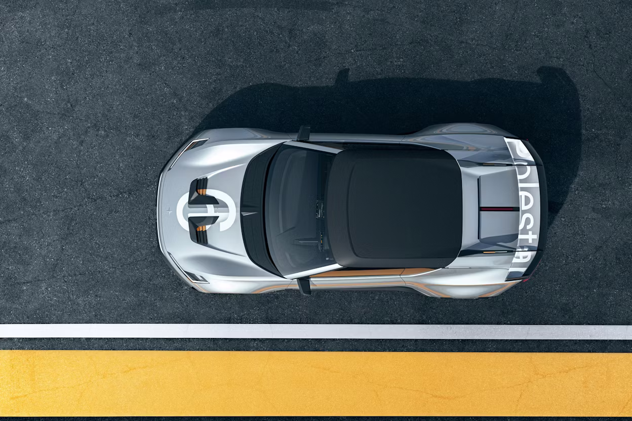 Top view of Polestar car on asphalt with white and yellow road markings.