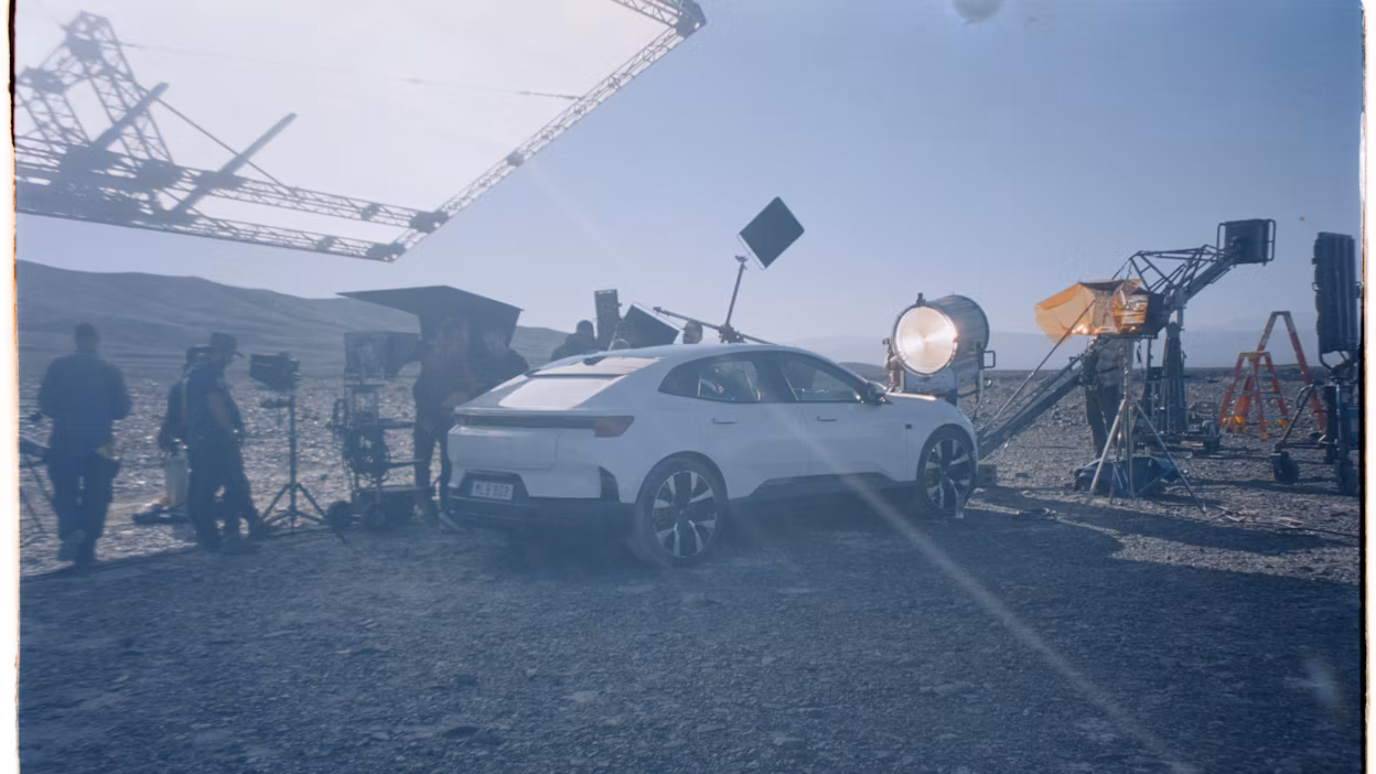 Polestar 4 in the desert surrounded by cameras and lights.