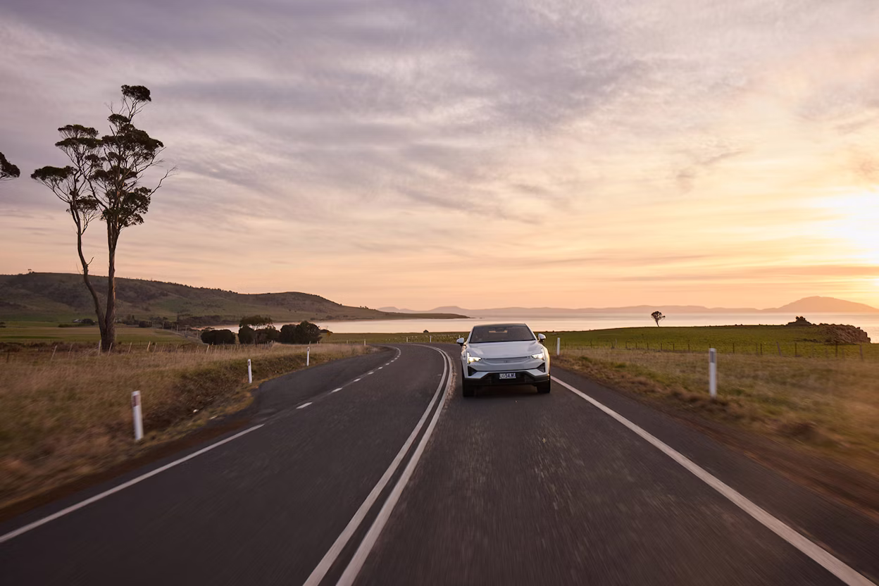 Polestar 3 driving down country road with sunset in background
