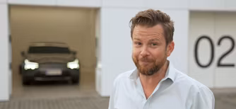 Polestar car parked in a garage with white walls and the number 02 displayed on the right side.