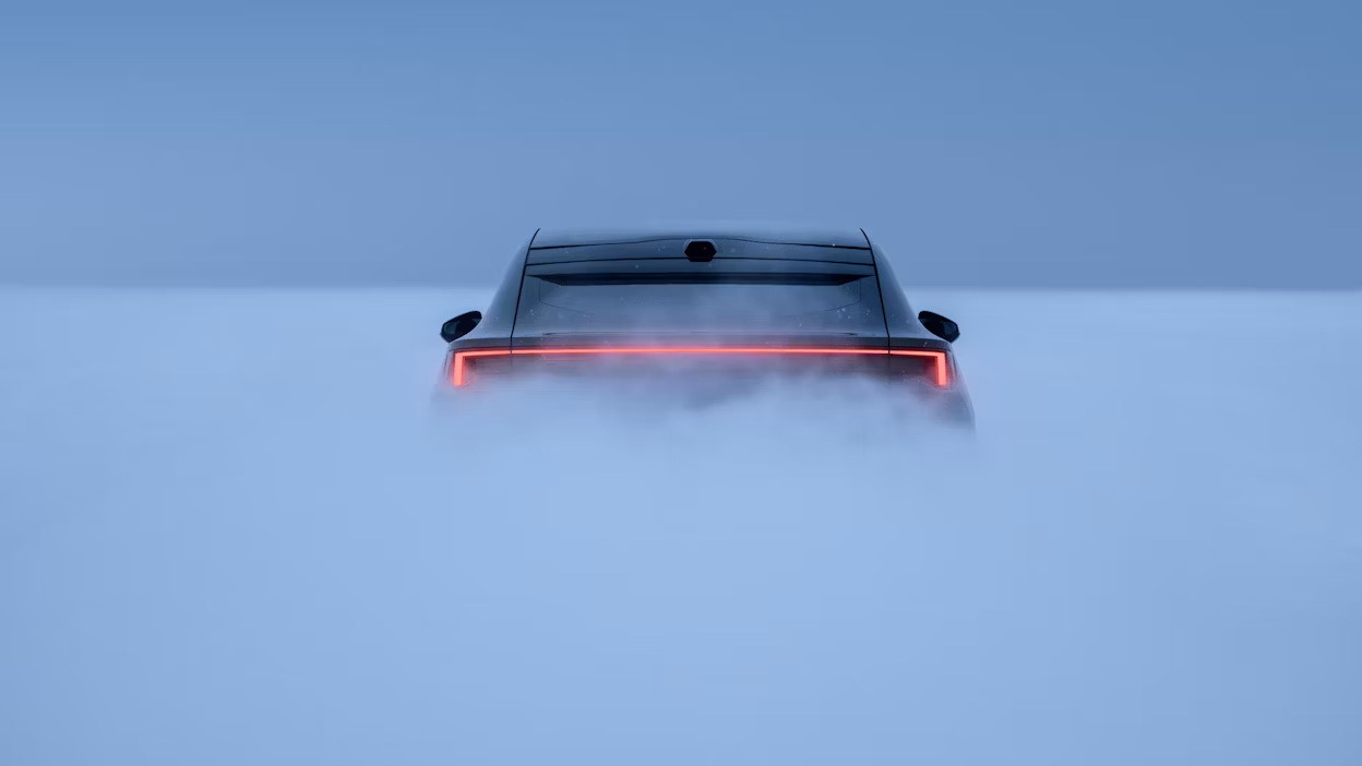 Rear view of a Polestar 4 with illuminated taillights surrounded by fog