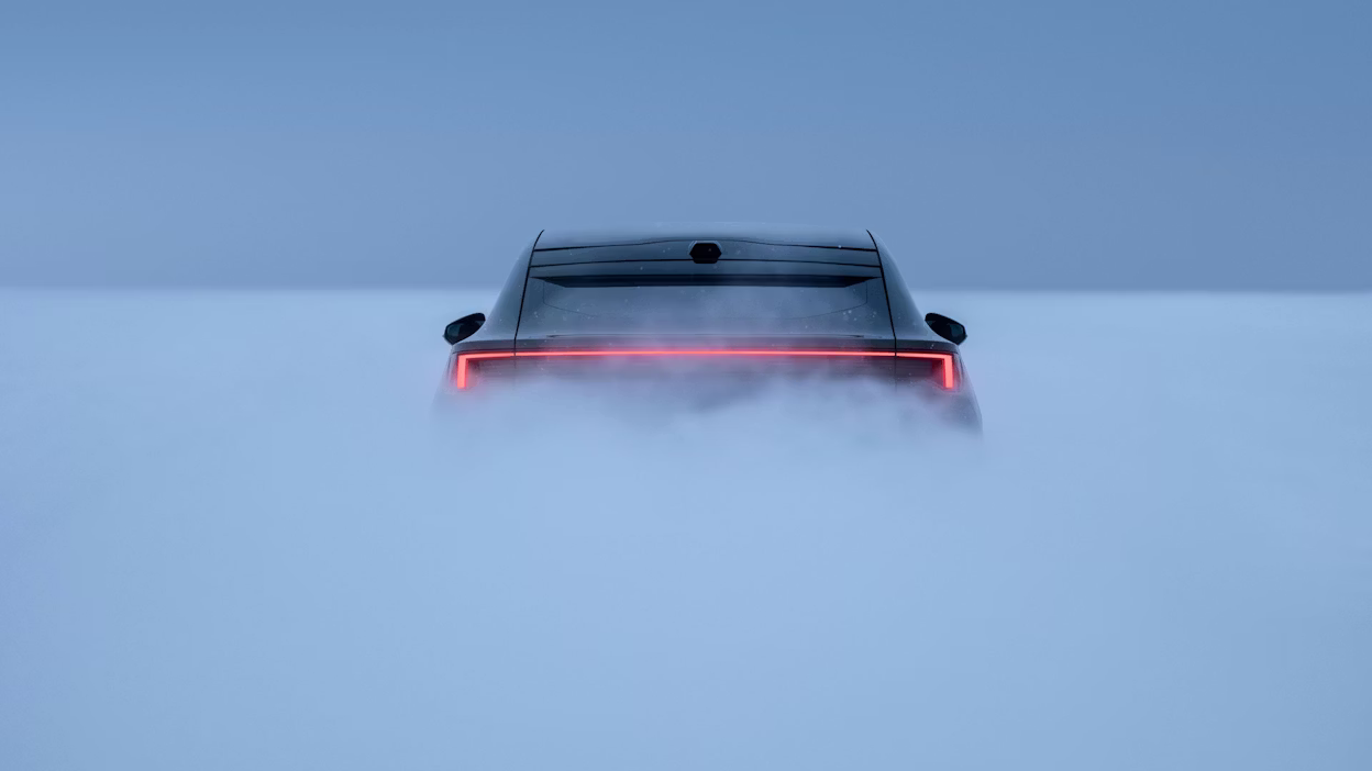 Rear view of a Polestar 4 with illuminated taillights surrounded by fog