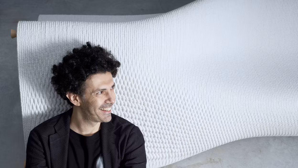 Man standing in front of sculpture