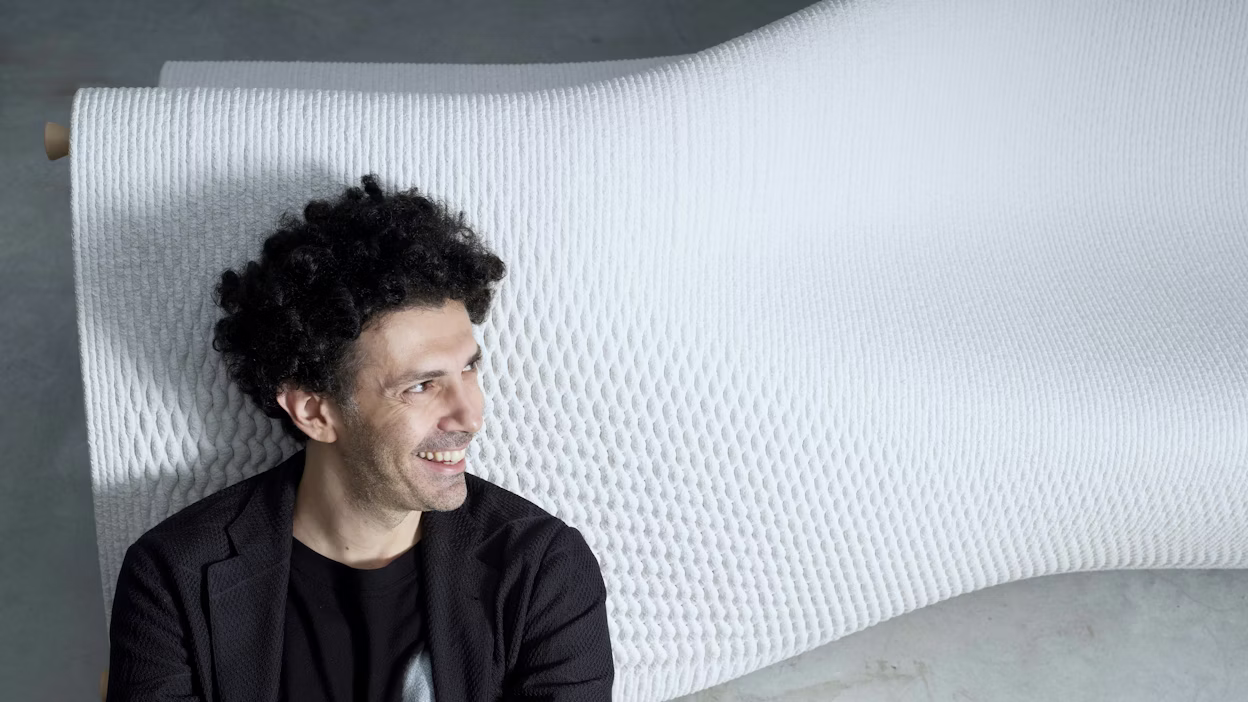 Man standing in front of sculpture