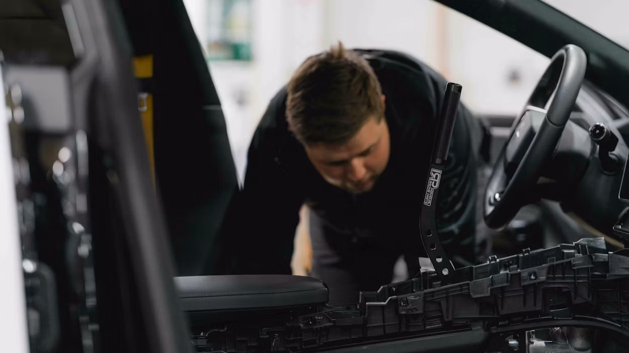 An engineer inspecting the inside of a car