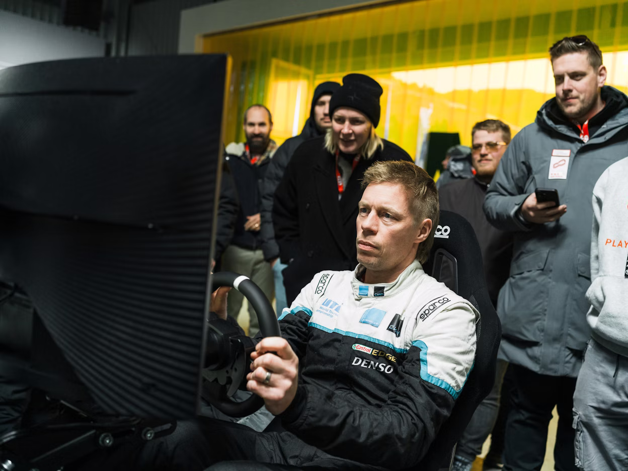 Attendees watching racing simulator