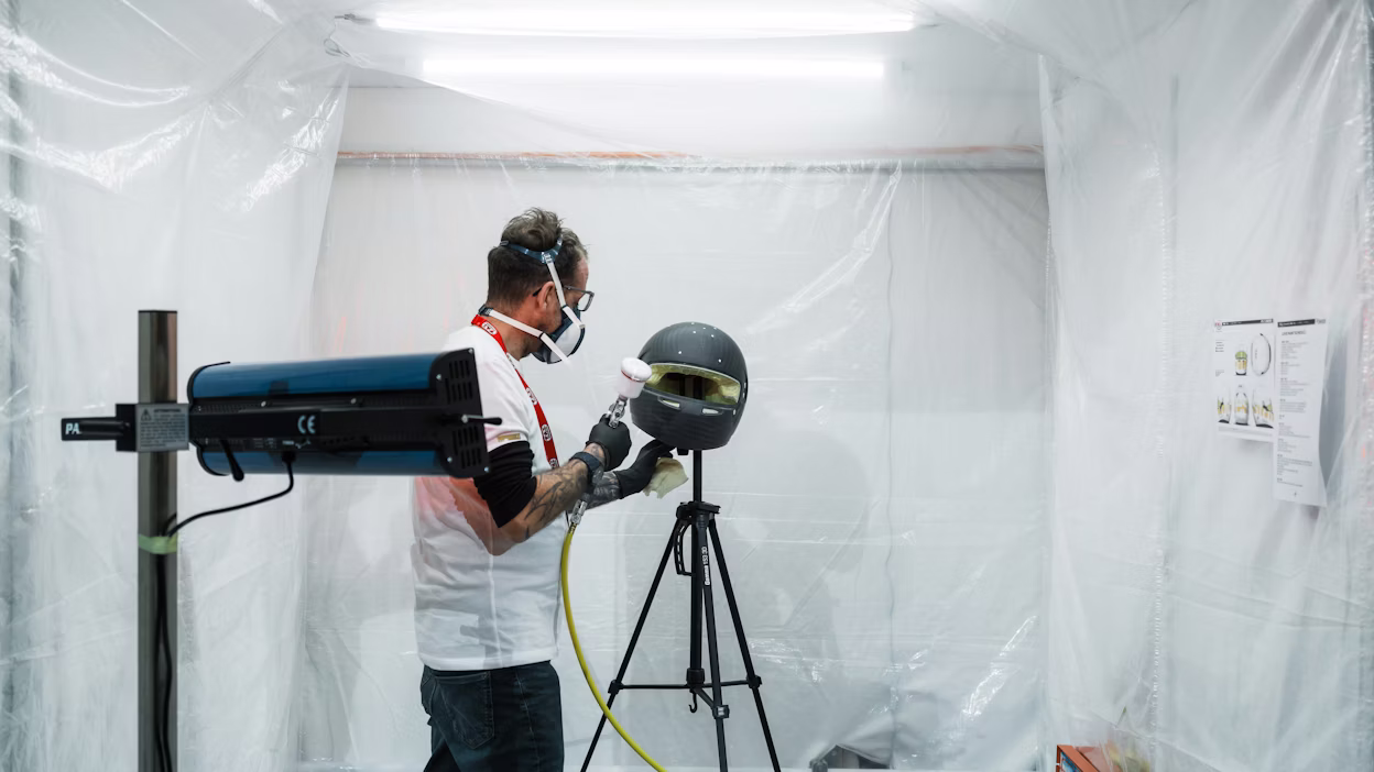A racing helmet getting spray painted