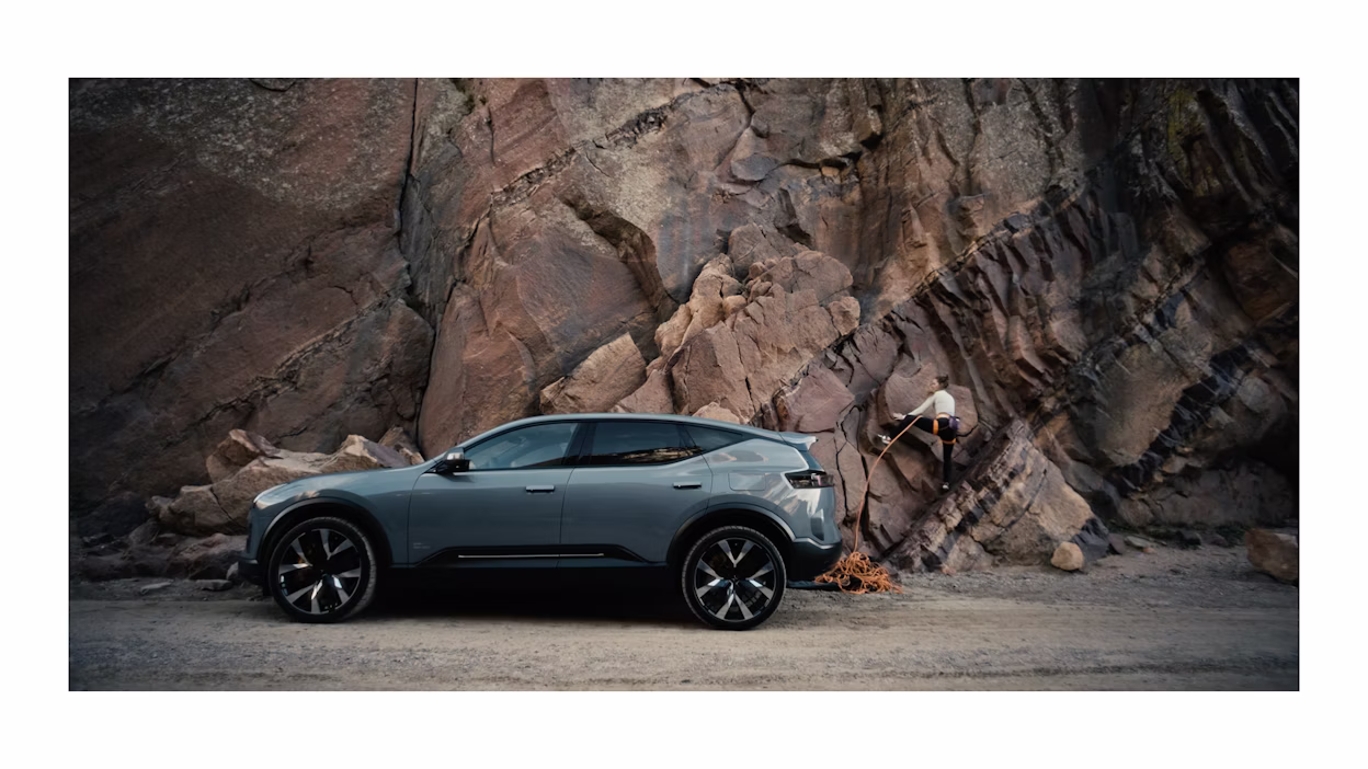 Wide shot of Margo Hayes climbing a rock.