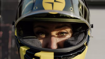 Woman wearing black and yellow Polestar racing helmet