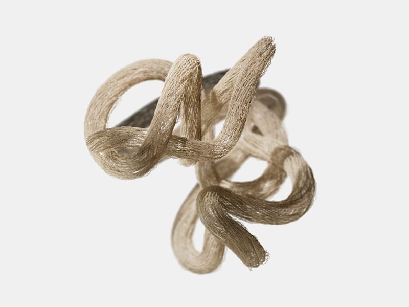 Close-up of intertwined beige fibers against a white background.