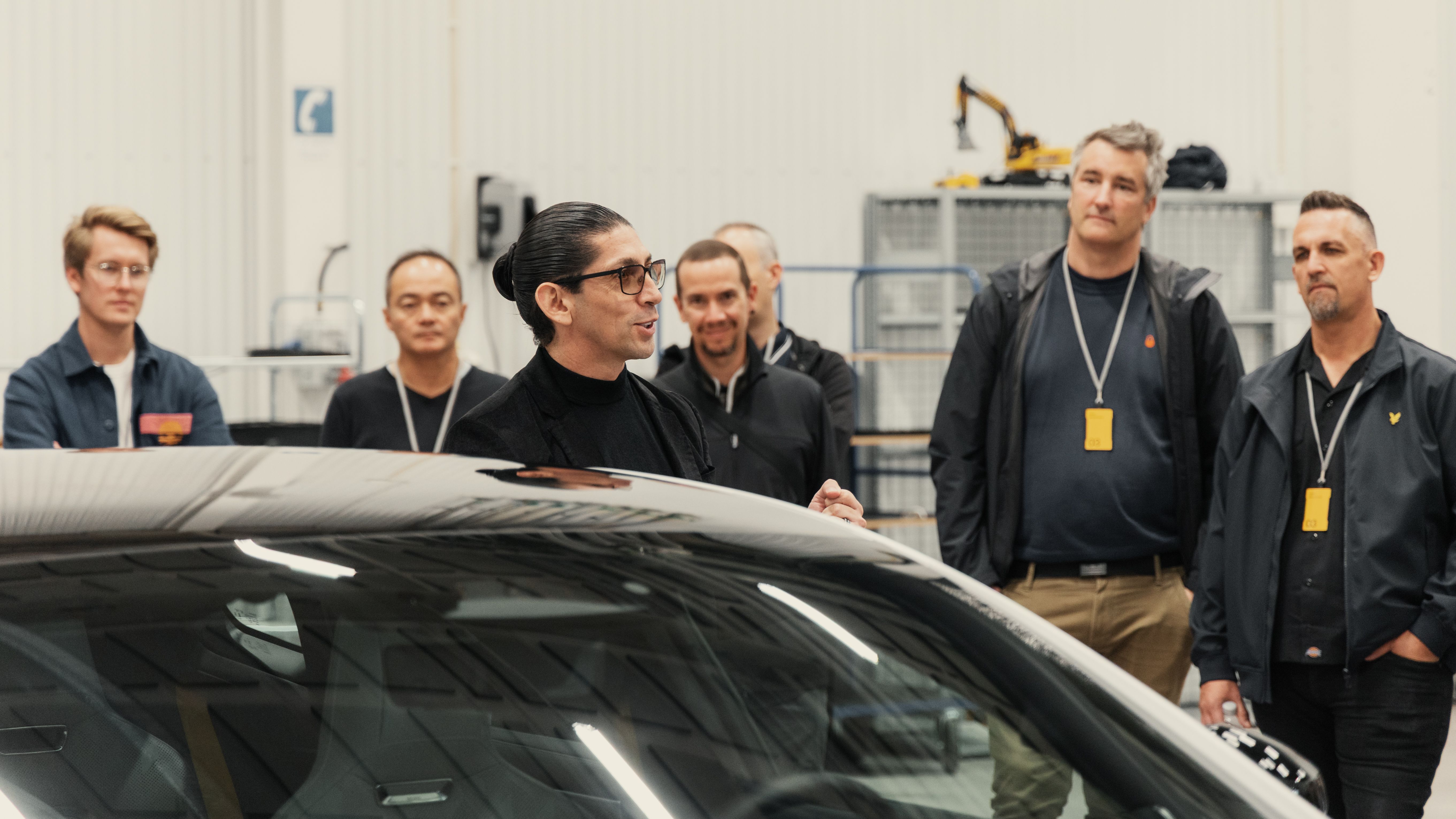 People listening to a car presentation