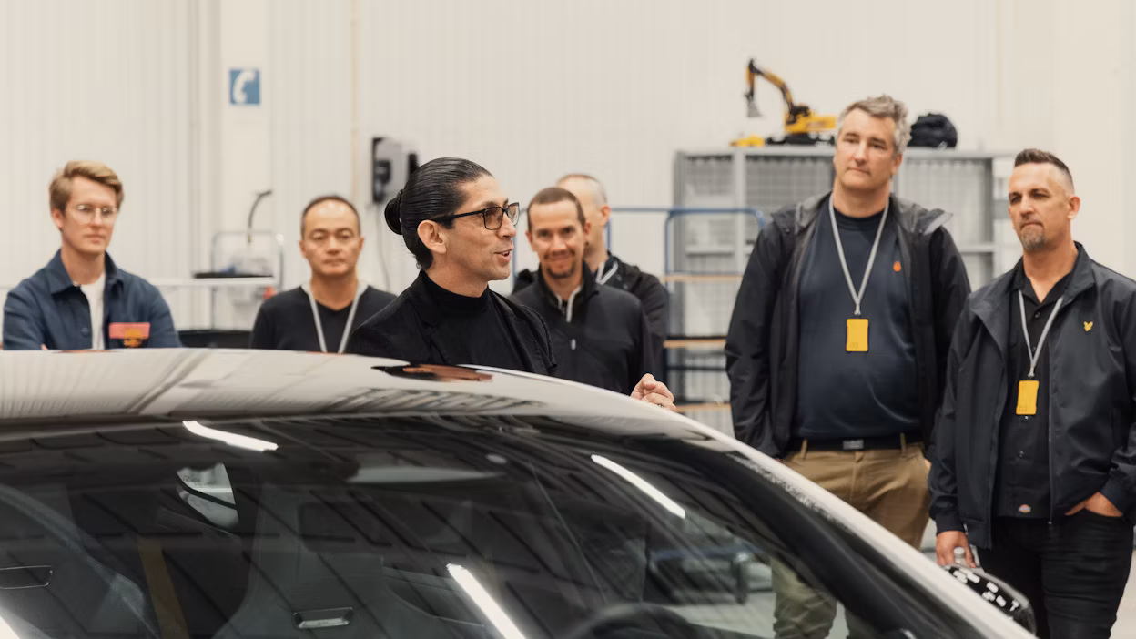 People listening to a car presentation