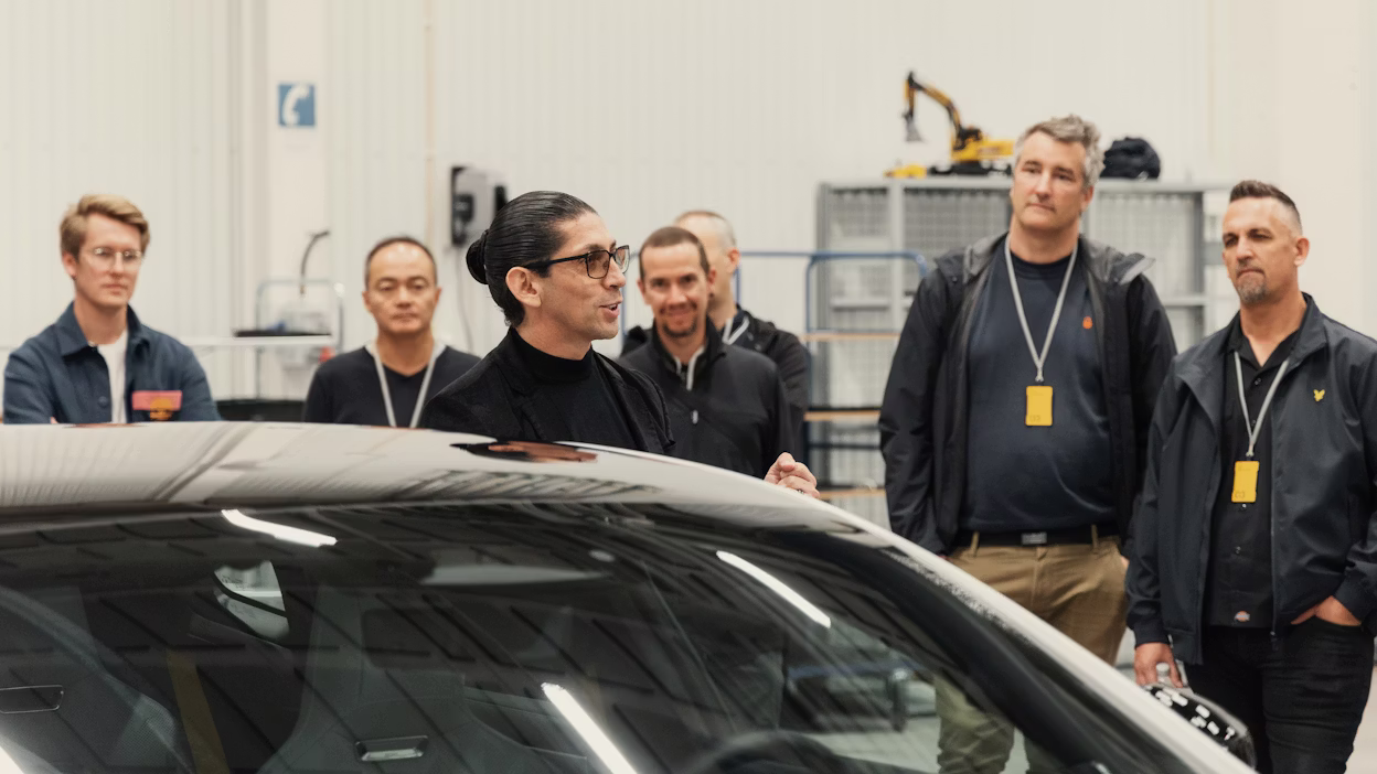 People listening to a car presentation