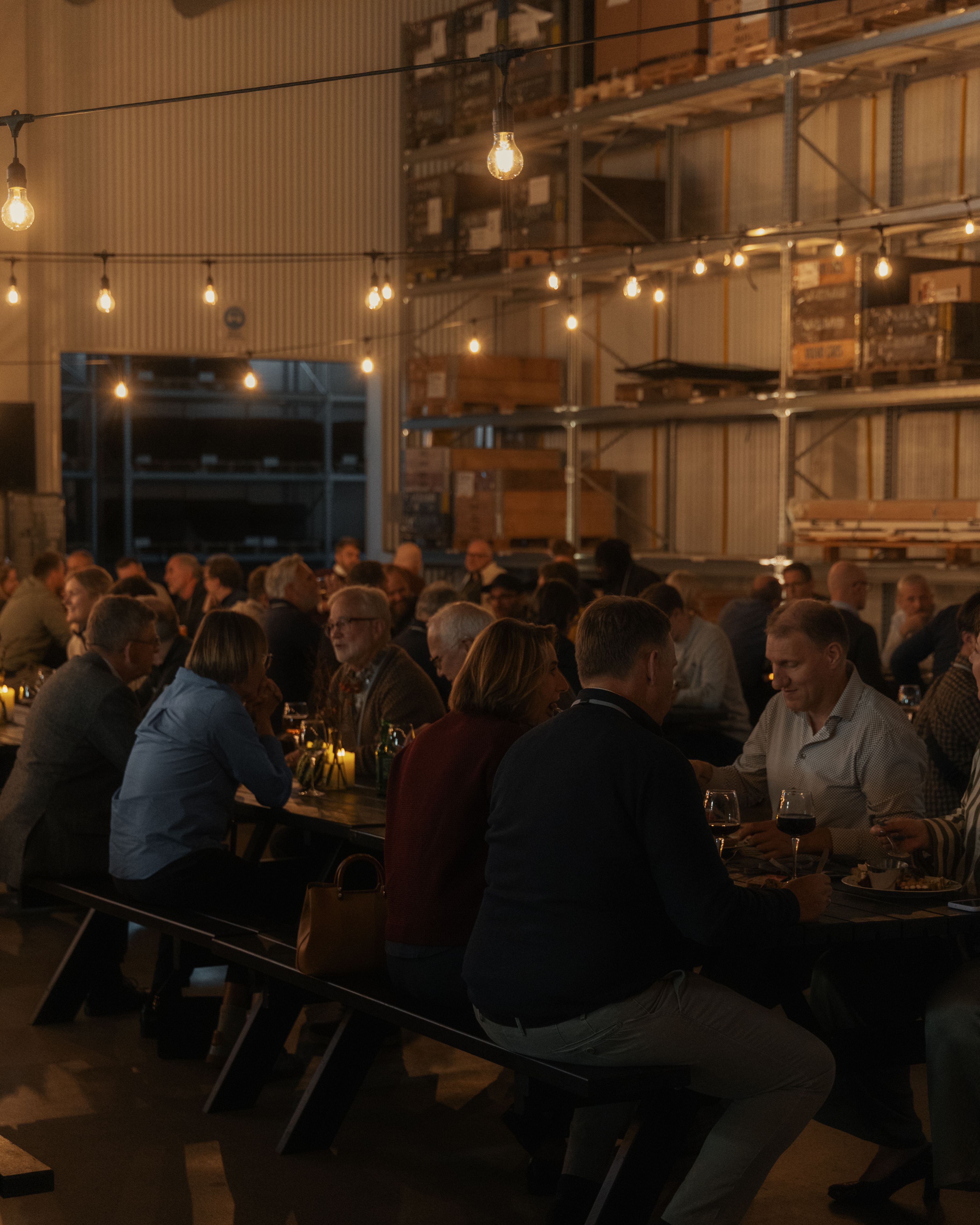 people having dinner in a dark room with cosy lights
