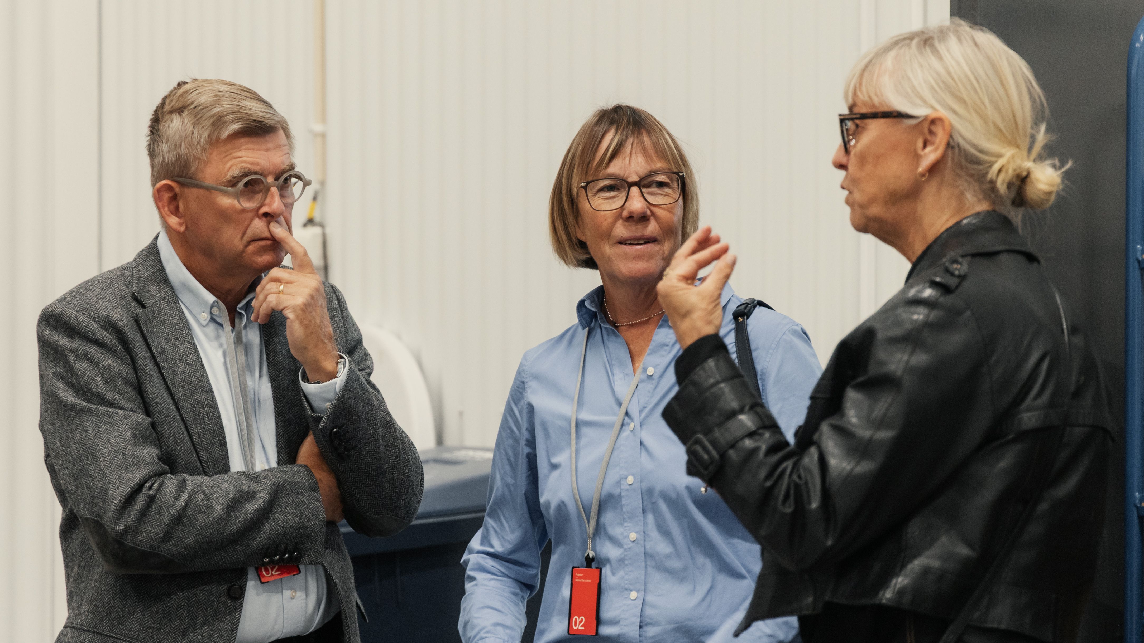 three persons talking
