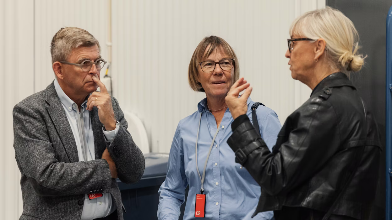 three persons talking