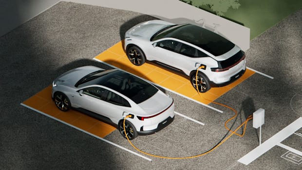 Polestar 3 and Polestar 4 parked in charging stations with cables connected to chargers on a paved surface.