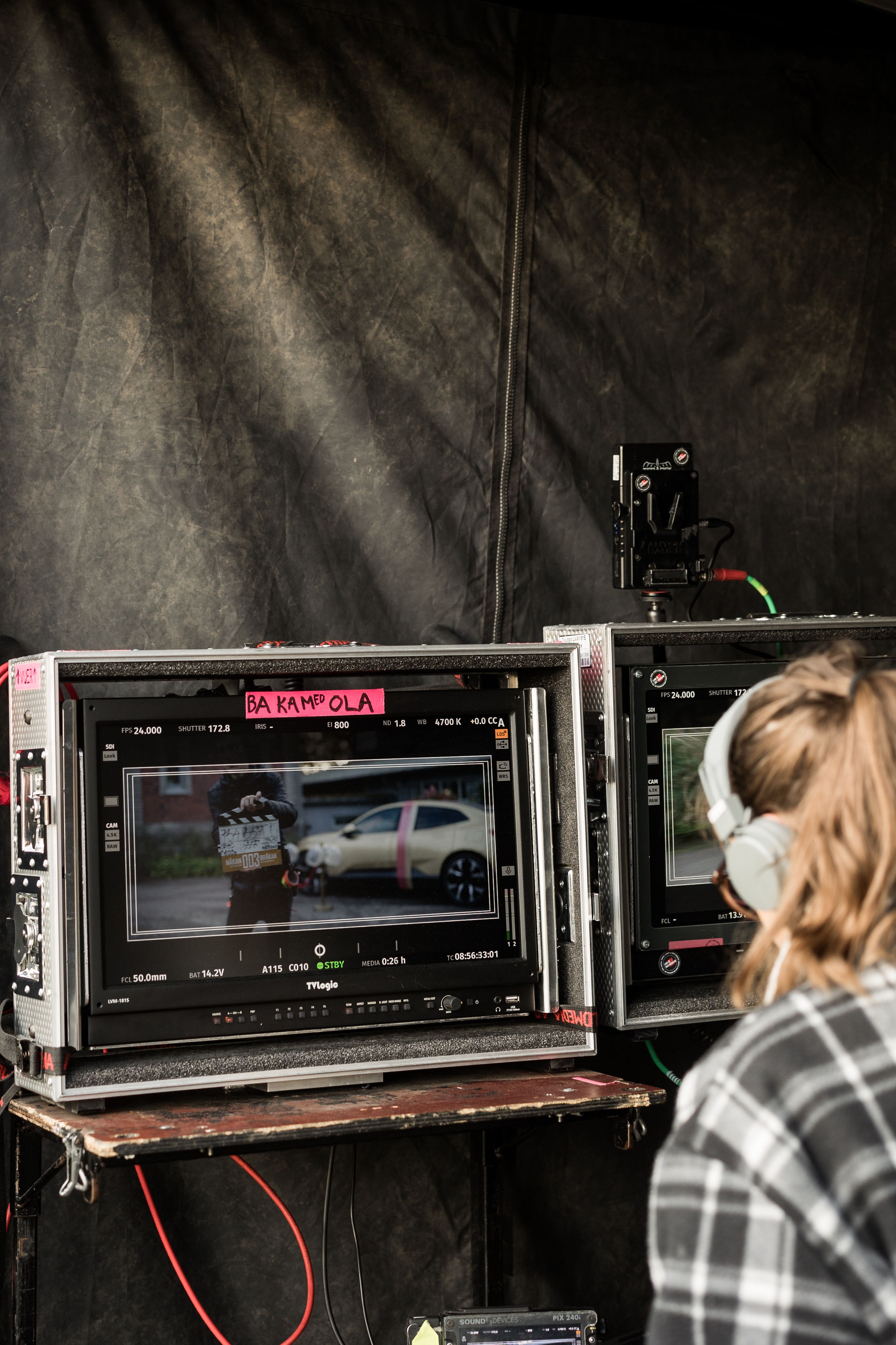 person sitting in front of a screen during a movie recording
