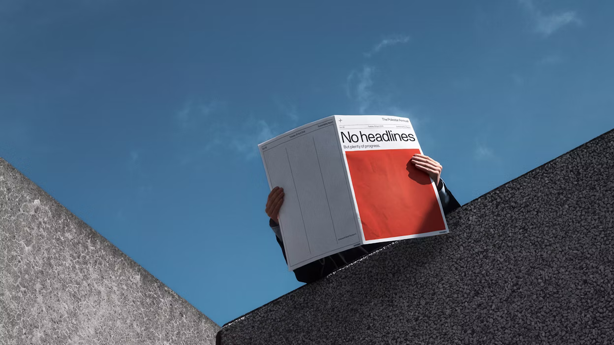 Newspaper being read with blue sky in background